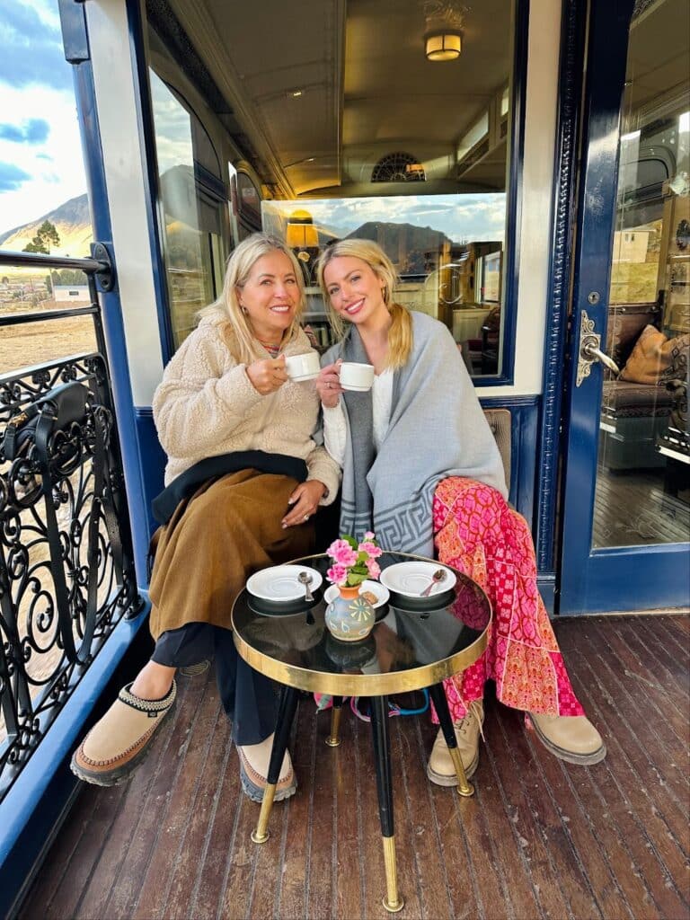 Sky and her mother onboard the luxury sleeper train in Peru with their coffee