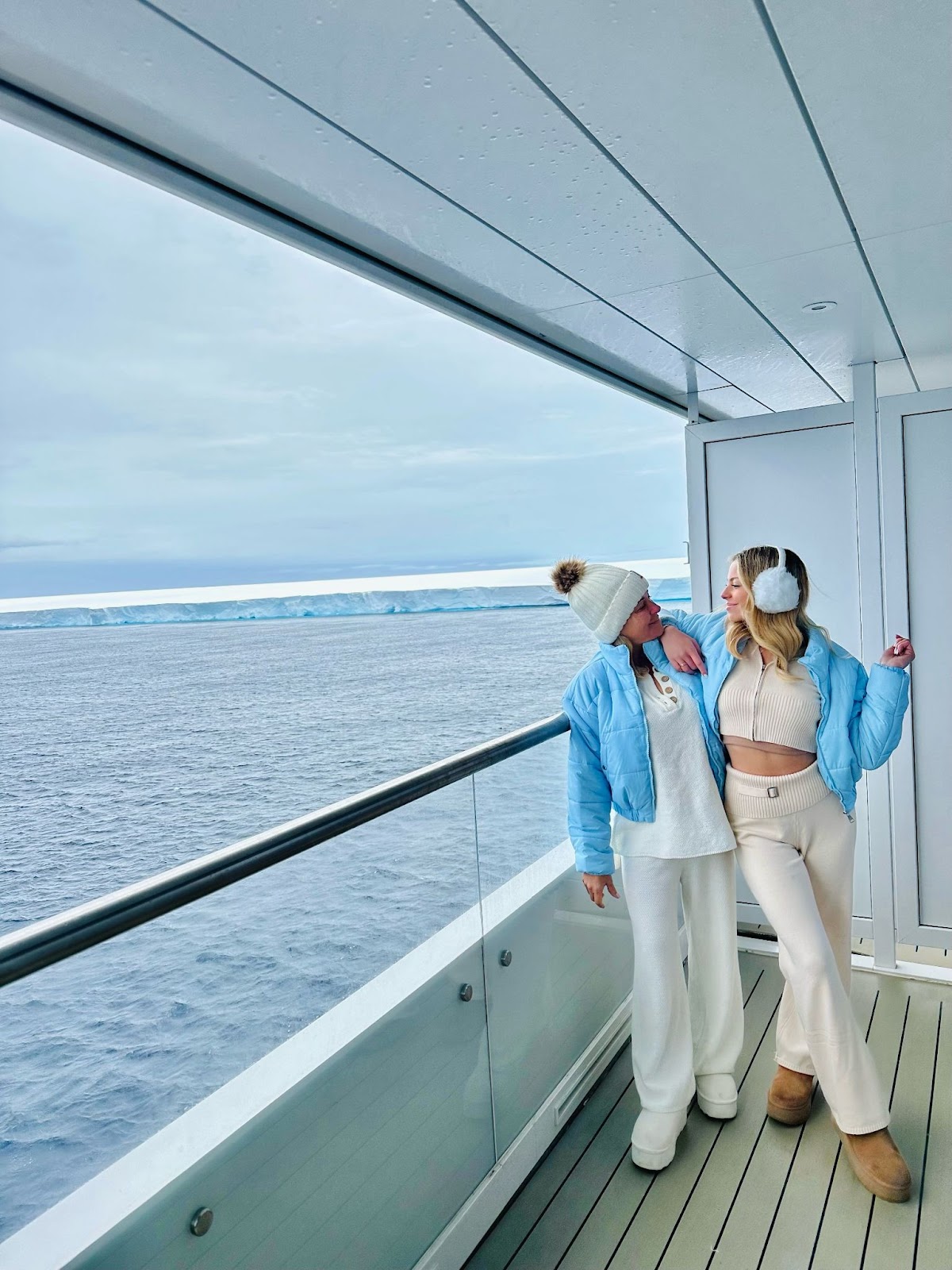 Sky and her mom on the balcony of the cruise shit in front of A23A the world's largest iceberg