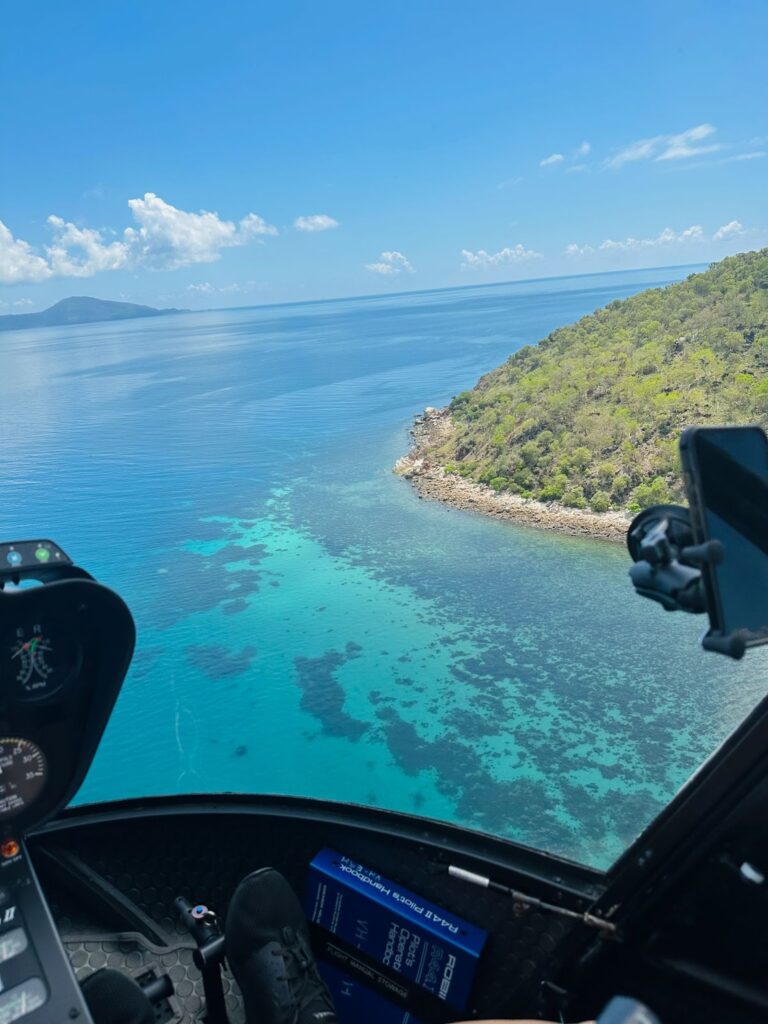 flying above the great barrier reef in australia in a helicopter