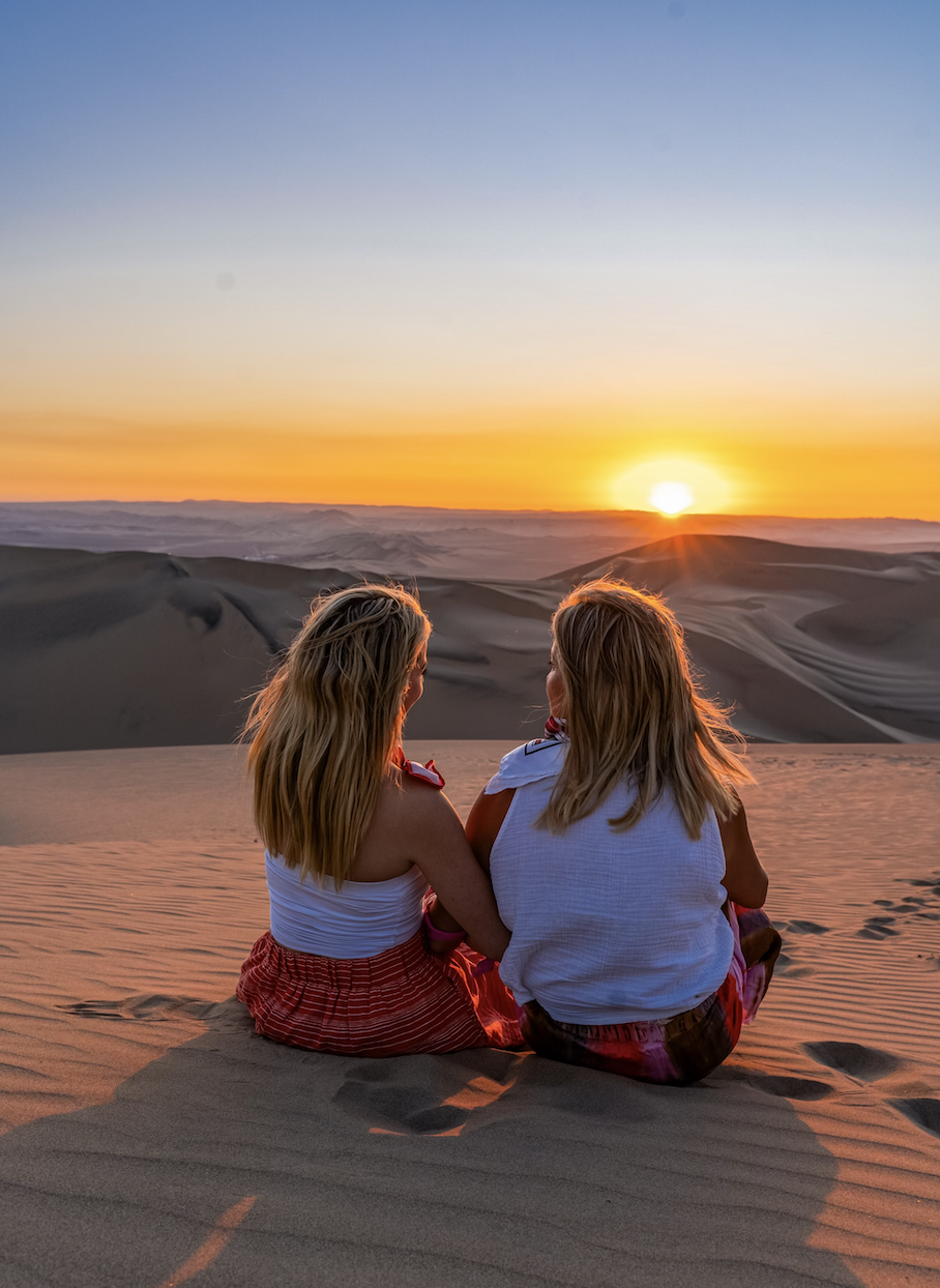 Sky and her mom watching the sunset in huacachina peru