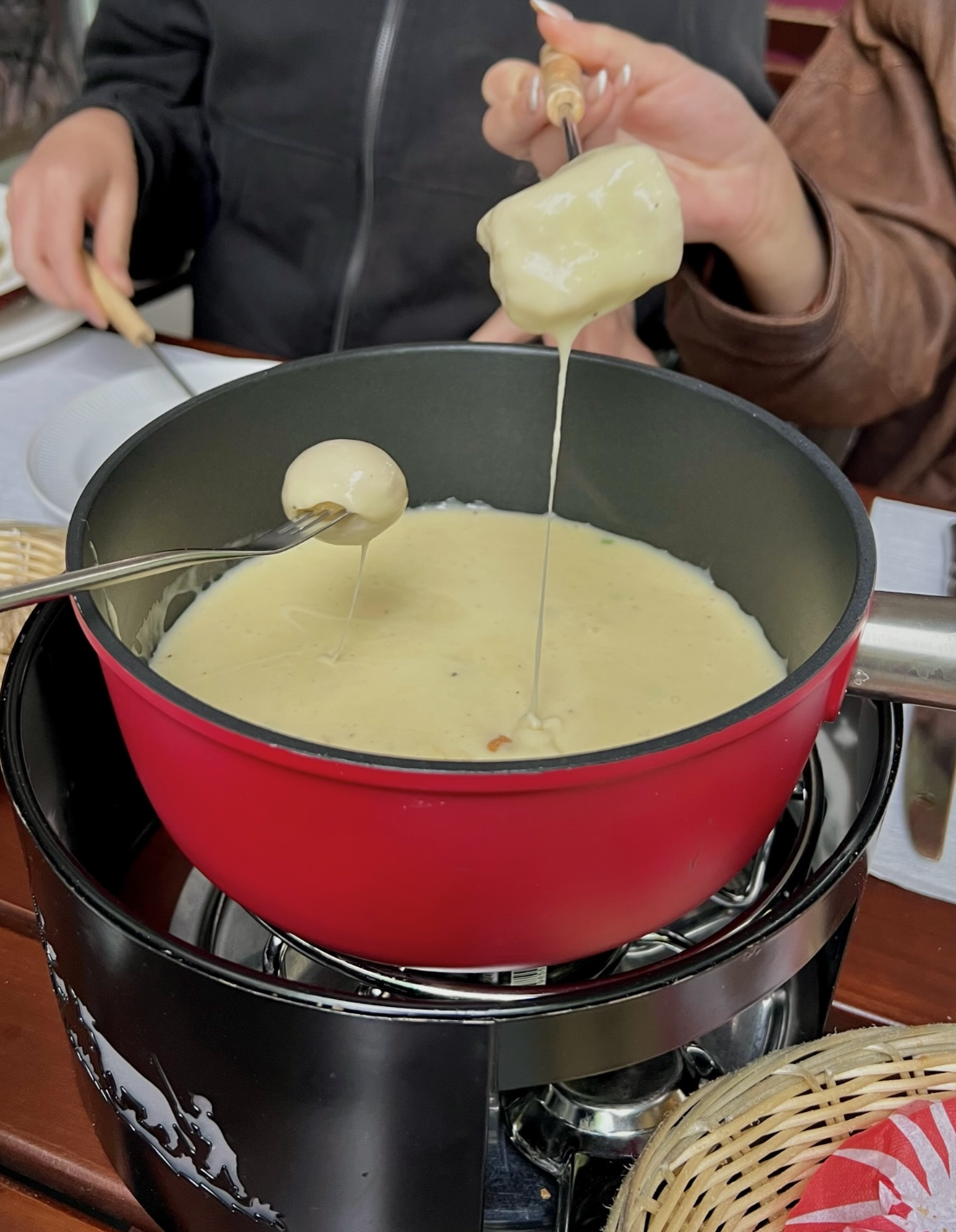 trying Swiss fondue in Lauterbrunnen, Switzerland